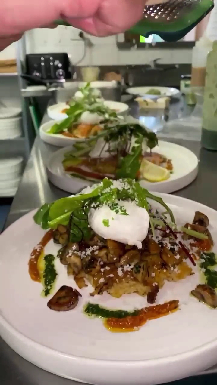 A plated brunch with a poached egg, fresh from the kitchen