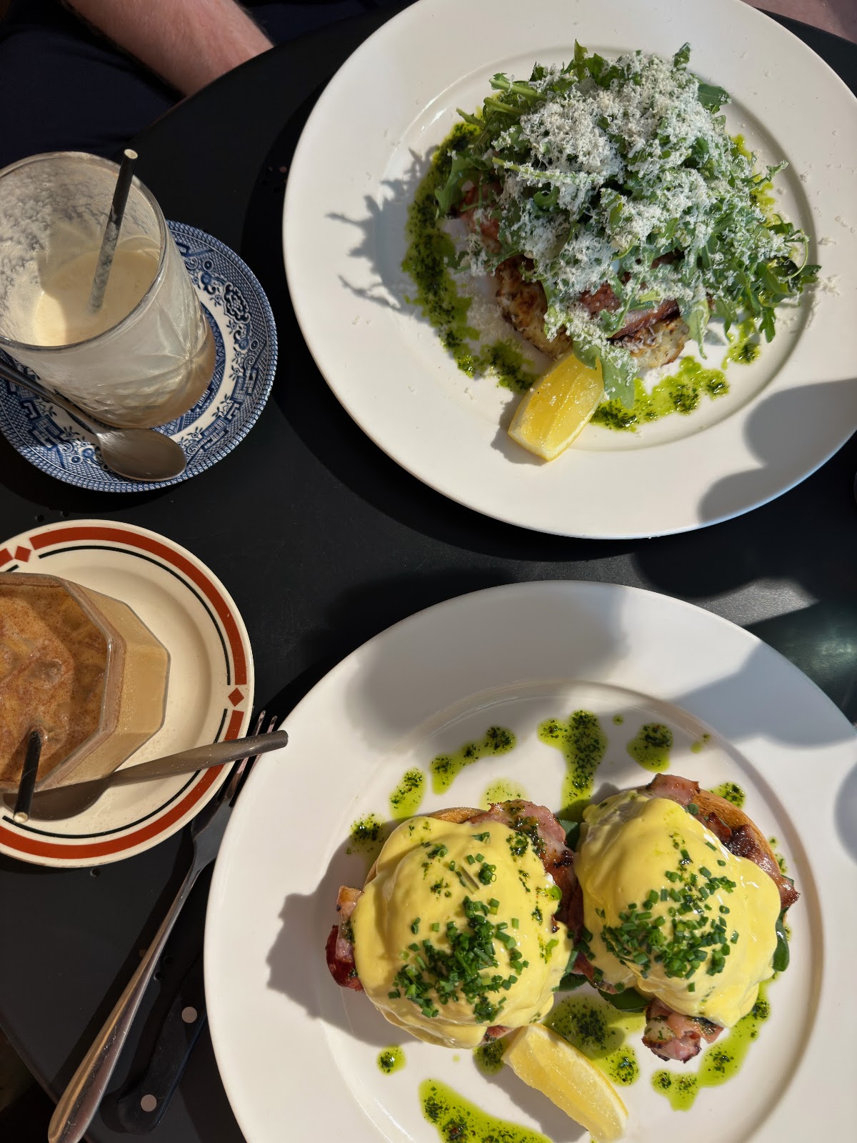 Eggs Benedict and a greens plate from above